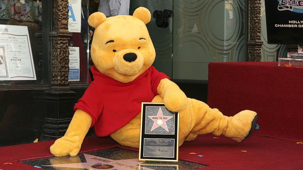 A person dressed in costume as Winnie-the-Pooh, pictured receiving a star on the Walk of Fame in Los Angeles