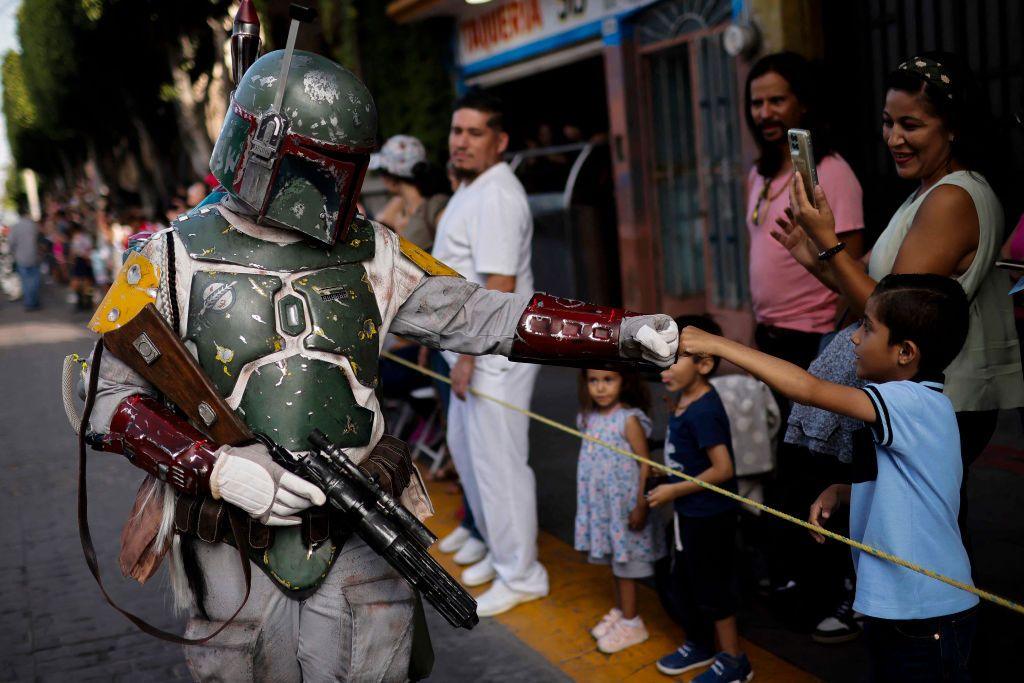 A Star Wars fan dressed as Boba Fett takes part in a parade