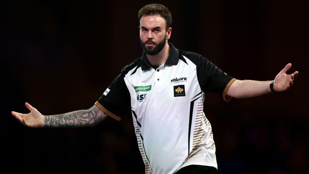 Ross Smith celebrates a darts victory by opening his arms