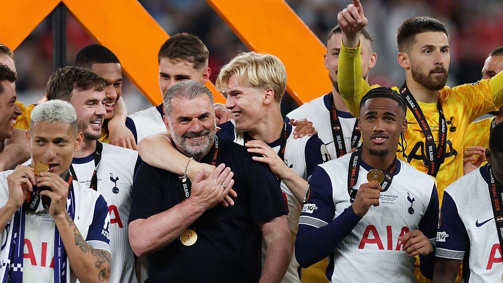 Ange Postecoglou celebrates with his players after winning the Europa League
