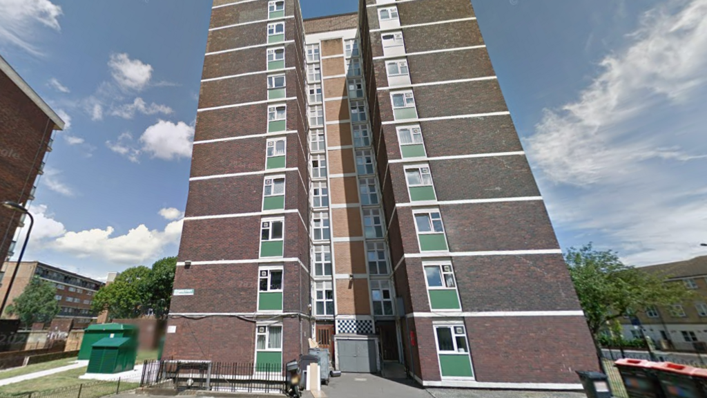 A view of the exterior of Cropley House, a high-rise brick building in east London