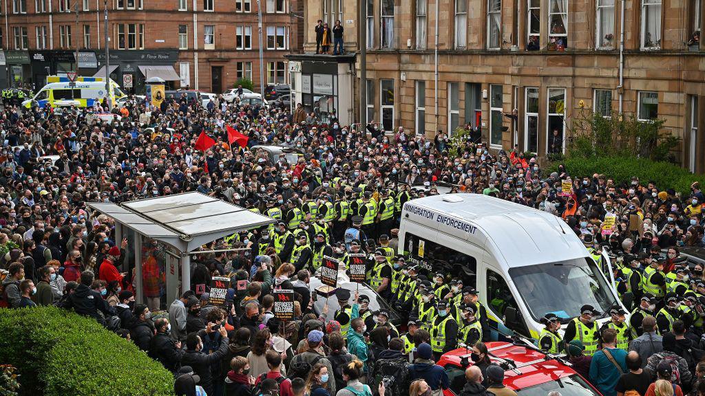 protestors block an immigration van from leaving Kenmure Street, Glasgow, in May 2021