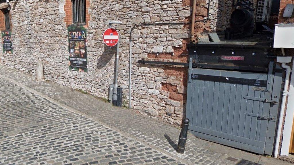 A street which has a grey door at the end which says move on it which is the name of the nightclub where two teenagers supplied drugs to teenagers. 