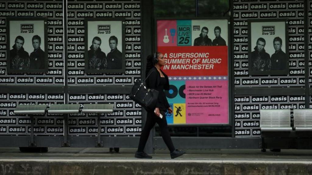 Posters of Oasis tour up at trams stop in Manchester
