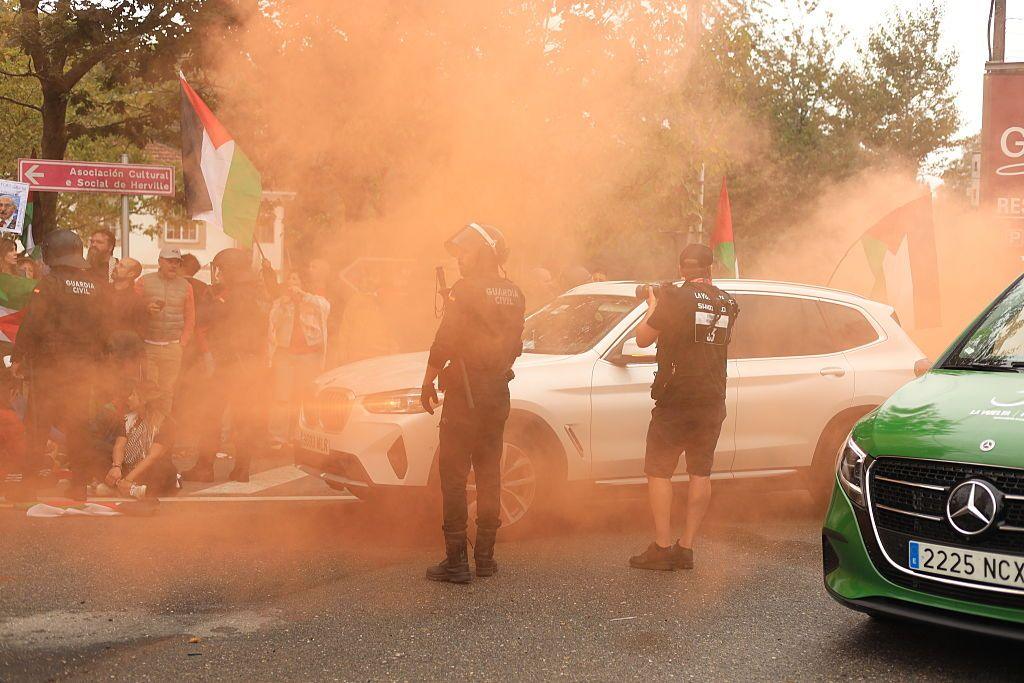 Protestors use flares as Police try to control them at the Vuelta a Espana
