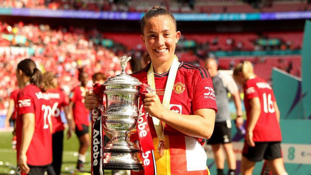 Maya Le Tissier holding the Women's FA Cup trophy