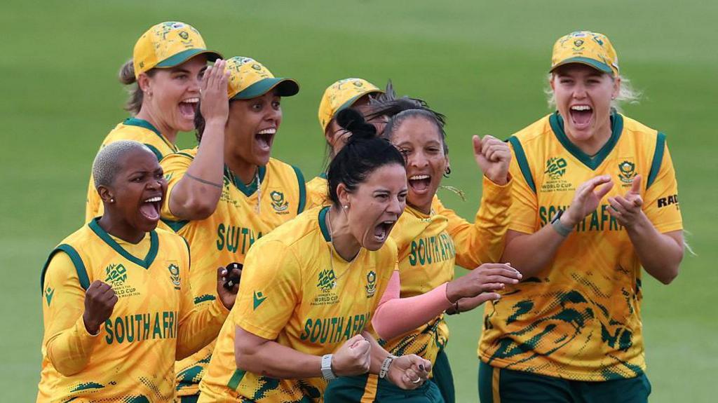 Marizanne Kapp (middle) celebrates taking a wicket with her South Africa team-mates