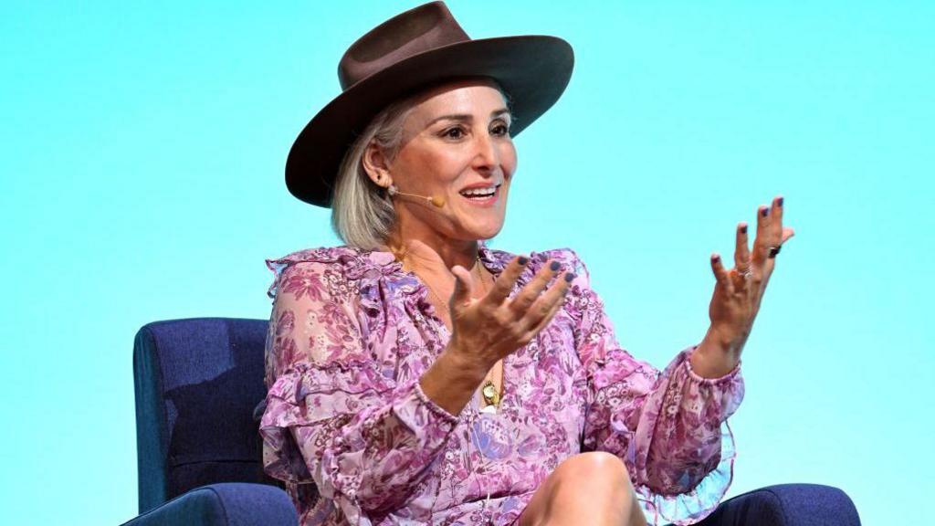 Ricki Lake in hat and floral dress