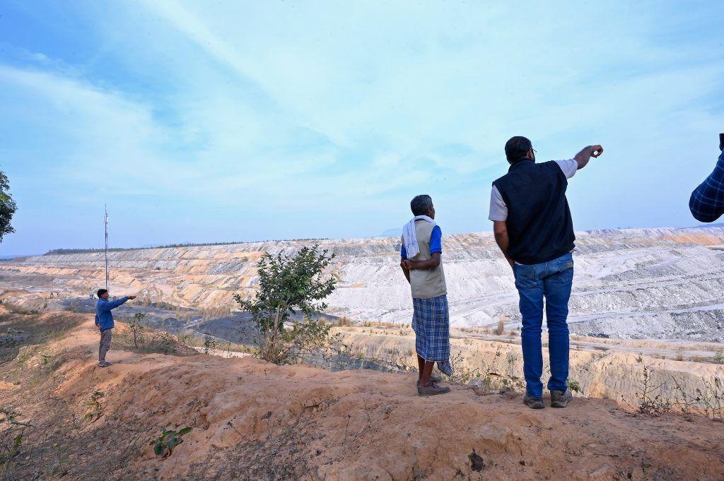 Alok looks over a mine in the forest