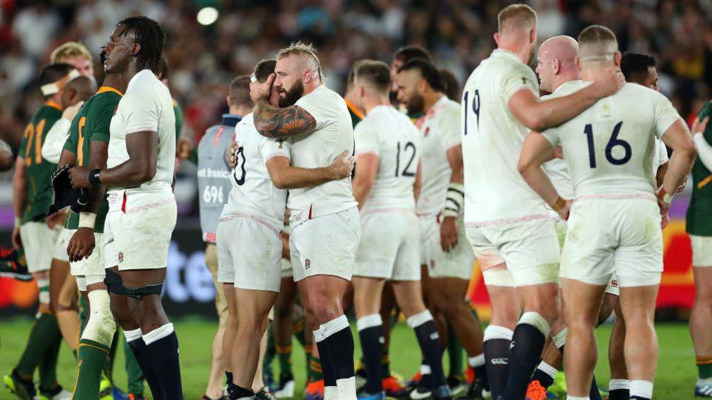 Joe Marler (centre) and England players console each other following defeat to South Africa 