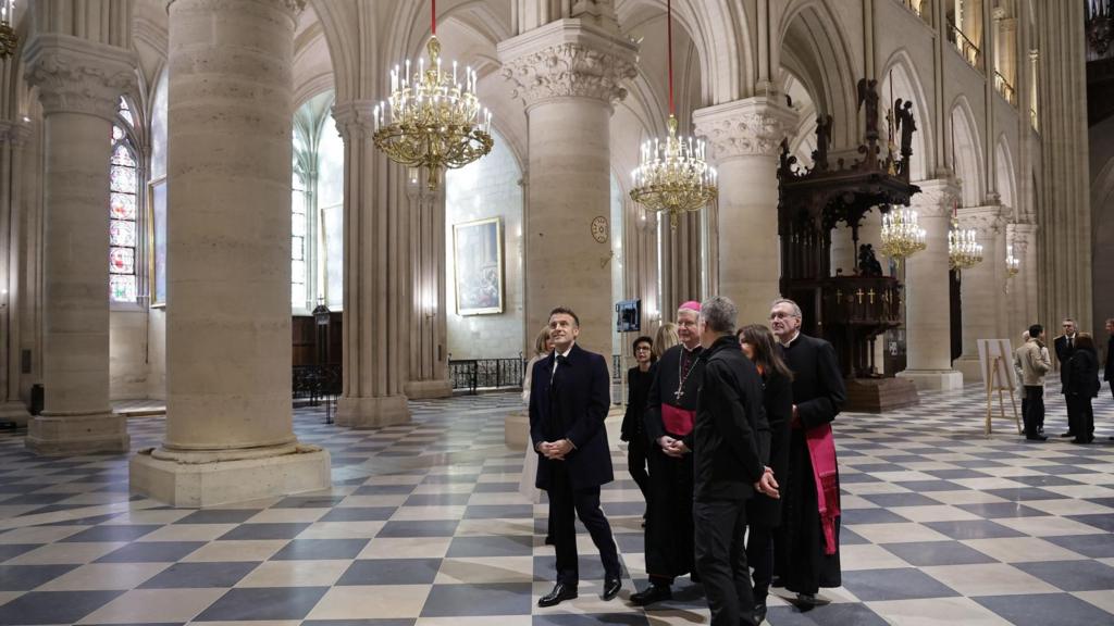 French President Emmanuel Macron (C) and and first lady Brigitte Macron (L) during a visit of Notre-Dame de Paris cathedral in Paris, France, 29 November 2024.