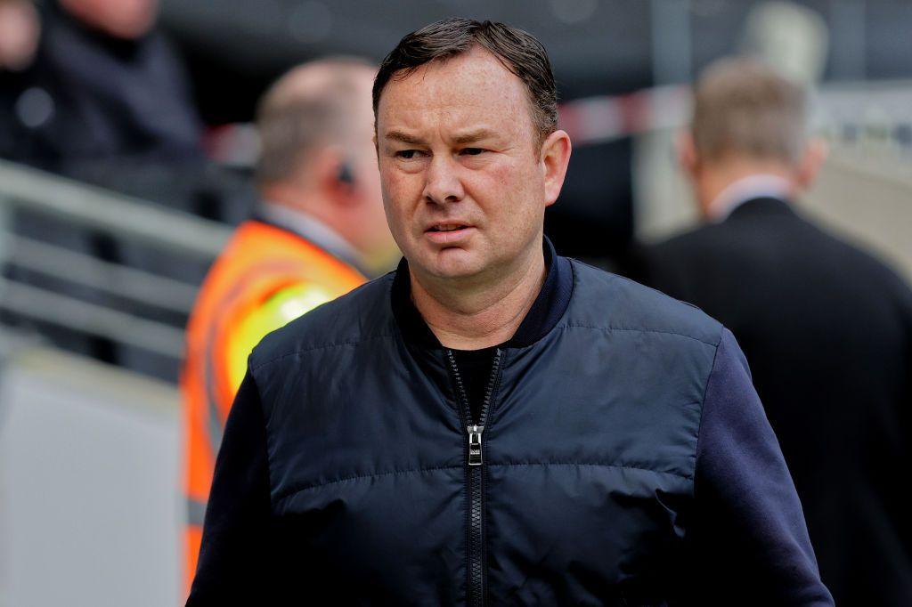 Morecambe manager Derek Adams scowls on the touchline during a League Two fixture