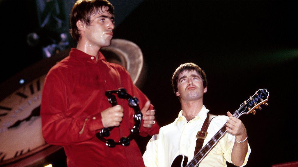 Liam and Noel Gallagher performing on stage