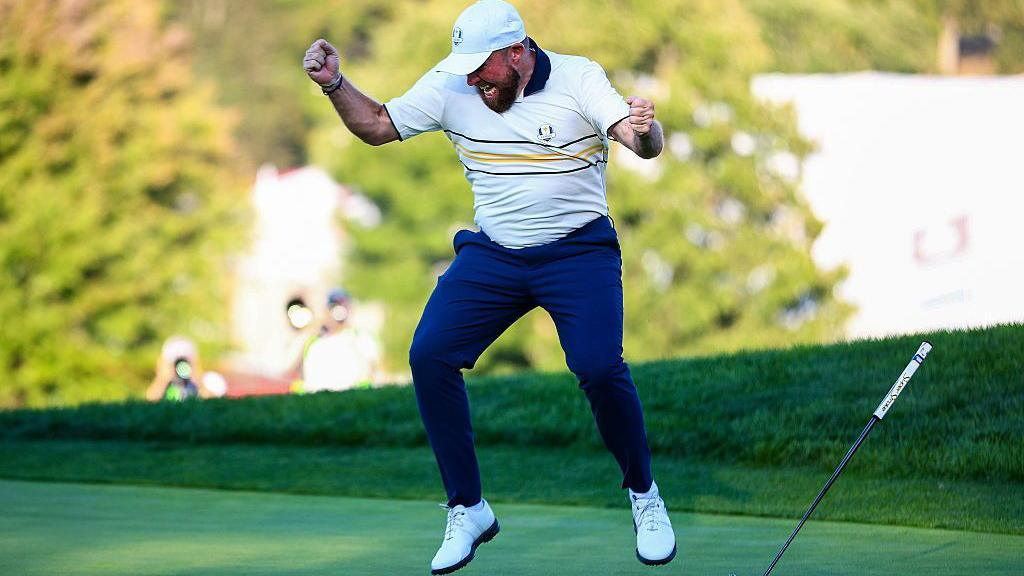 Shane Lowry jumping for joy on the 18th hole.