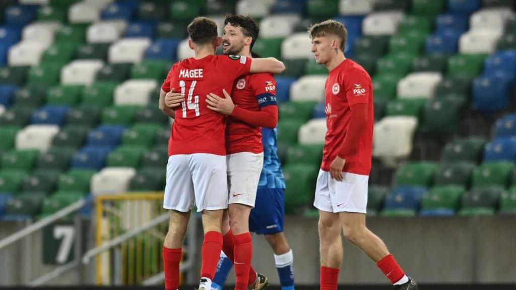 Larne's players celebrating against Genk