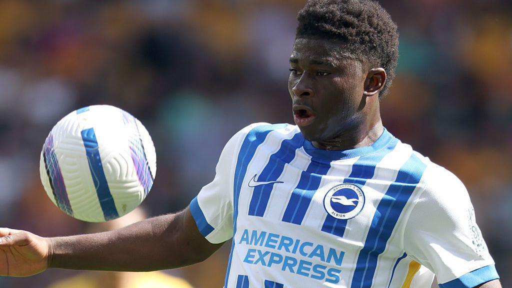 Carlos Baleba controls the ball with his chest while playing for Brighton