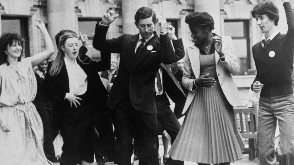 King Charles dancing with students in London. 