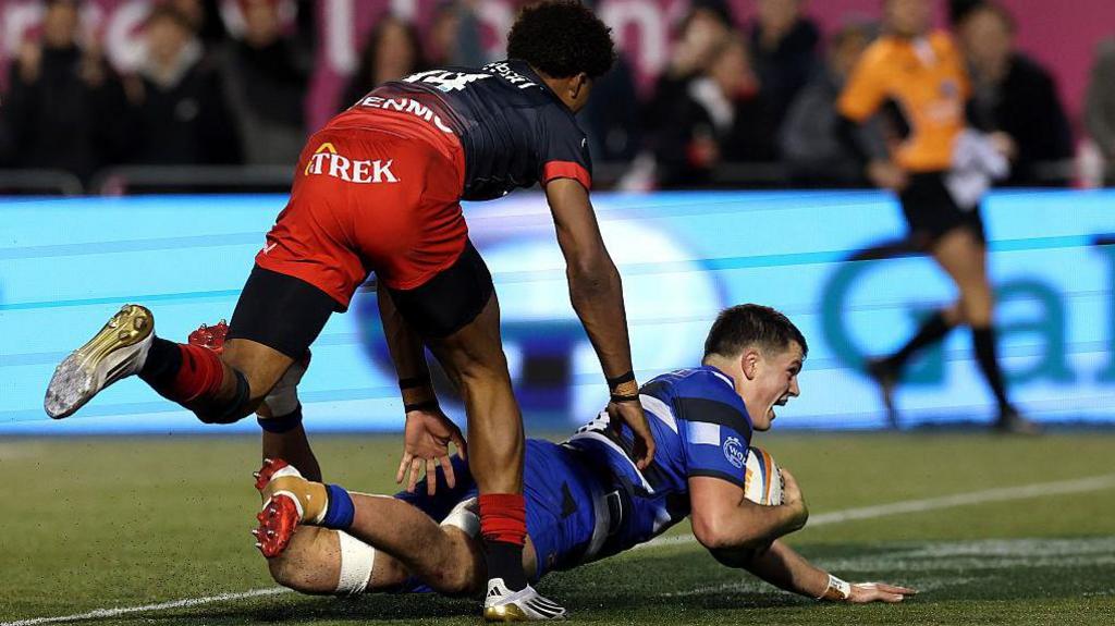 Arthur Green dives over the line to score for Bath against Saracens
