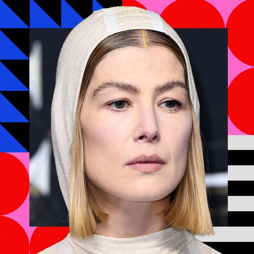 A picture of Rosamund Pike in a white hat and outfit