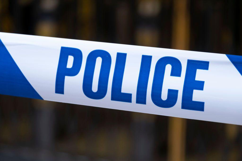 "Police" written in blue lettering on white tape.