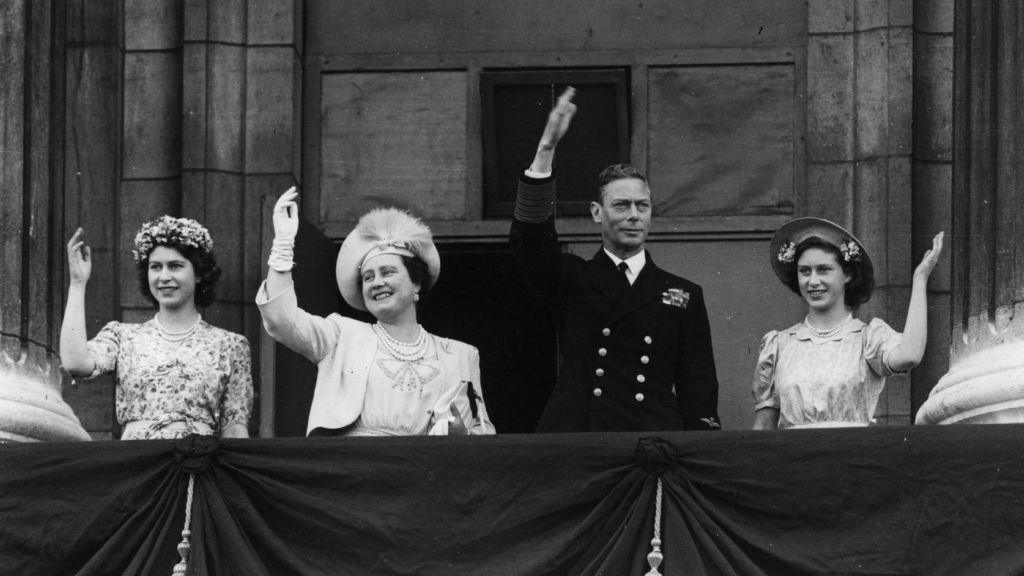 King George VI, Queen Elizabeth and Princesses Elizabeth and Margaret waving from the balcony of Buckingham Palace on VJ Day.