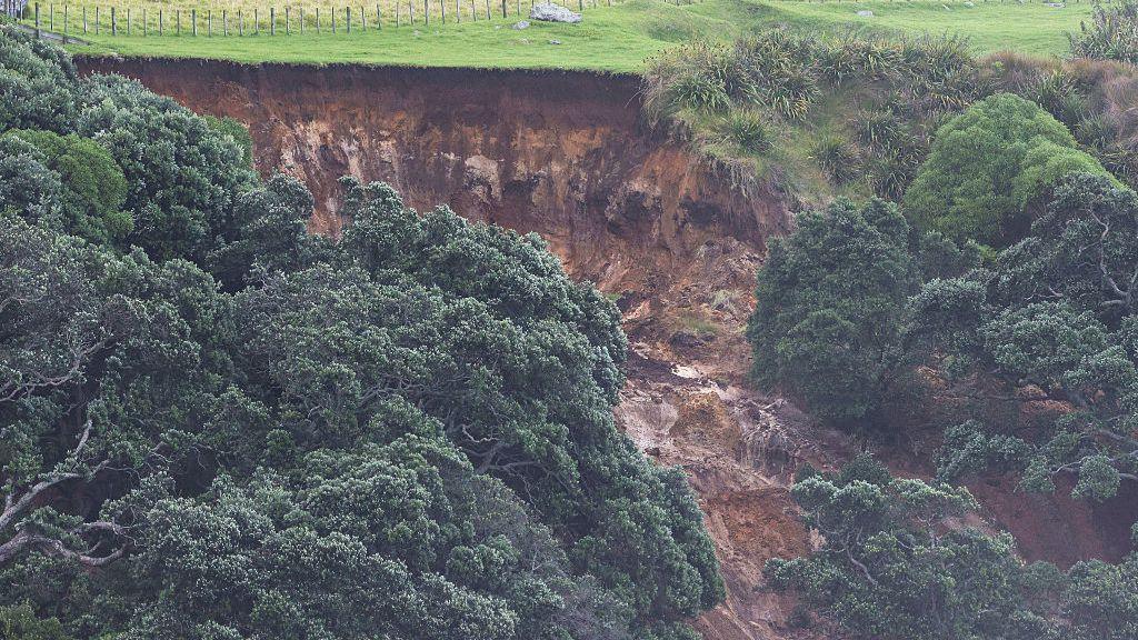 Rescuers working in the debris of a landslide at a popular campsite in Mount Maunganui, New Zealand.