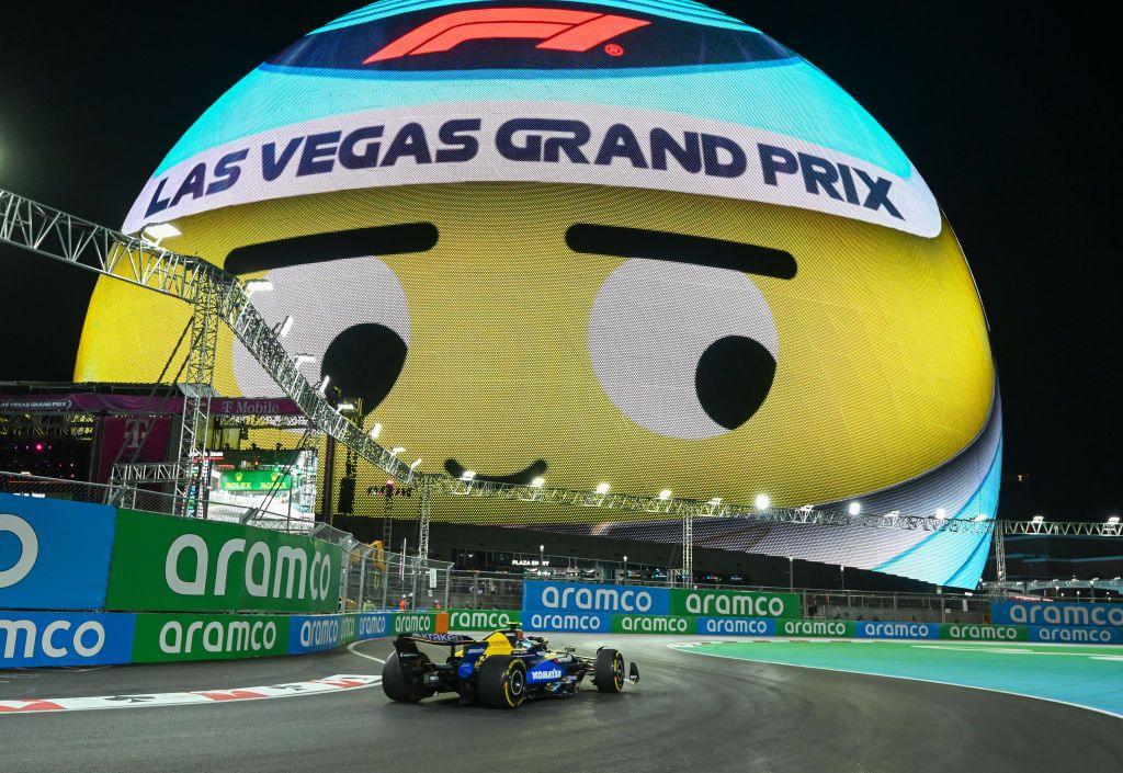 A Williams drives past the illuminated Sphere during first practice