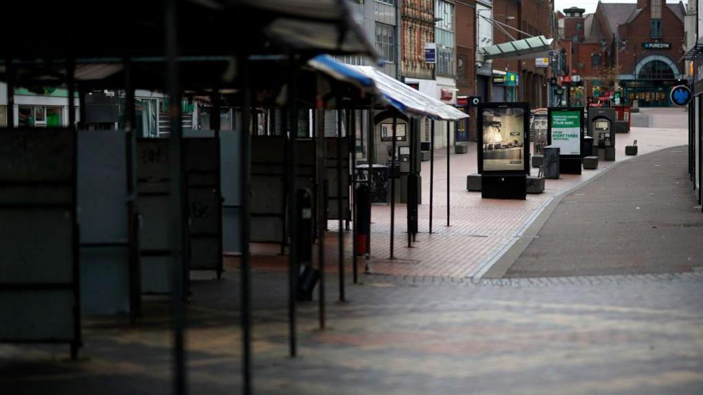 Walsall town centre. There is nobody on the street. Pure gym can be seen at the end of the road. 