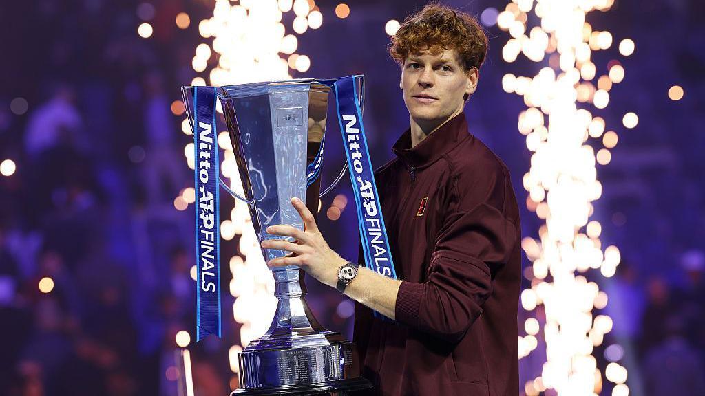 Jannik Sinner poses with the ATP Finals trophy