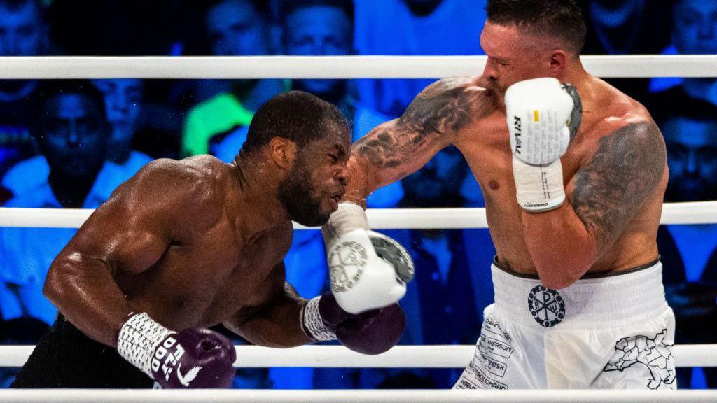 Daniel Dubois grimaces as he is punched by Oleksandr Usyk