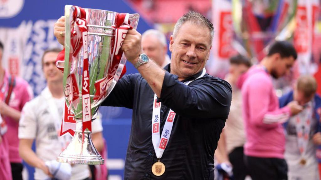 Scott Lindsey poses with the League Two play-off trophy