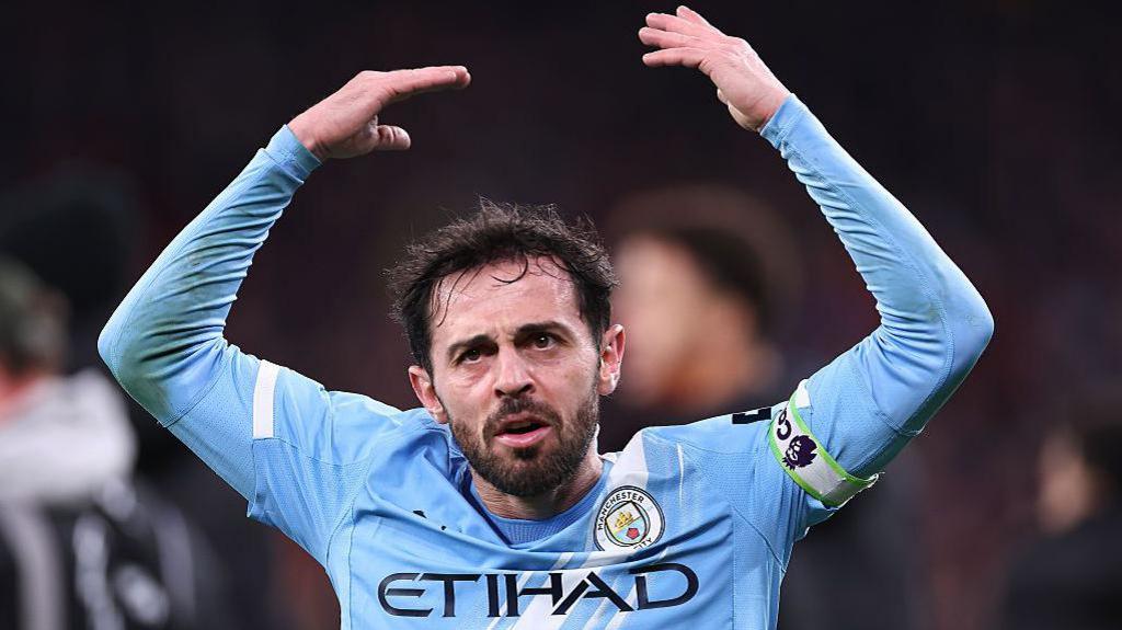 Bernardo Silva lifts arms to encourage fans