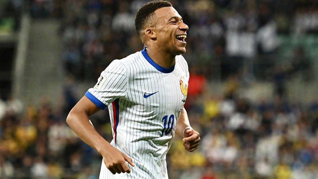 Kylian Mbappe smiles widely after scoring for France against Ukraine