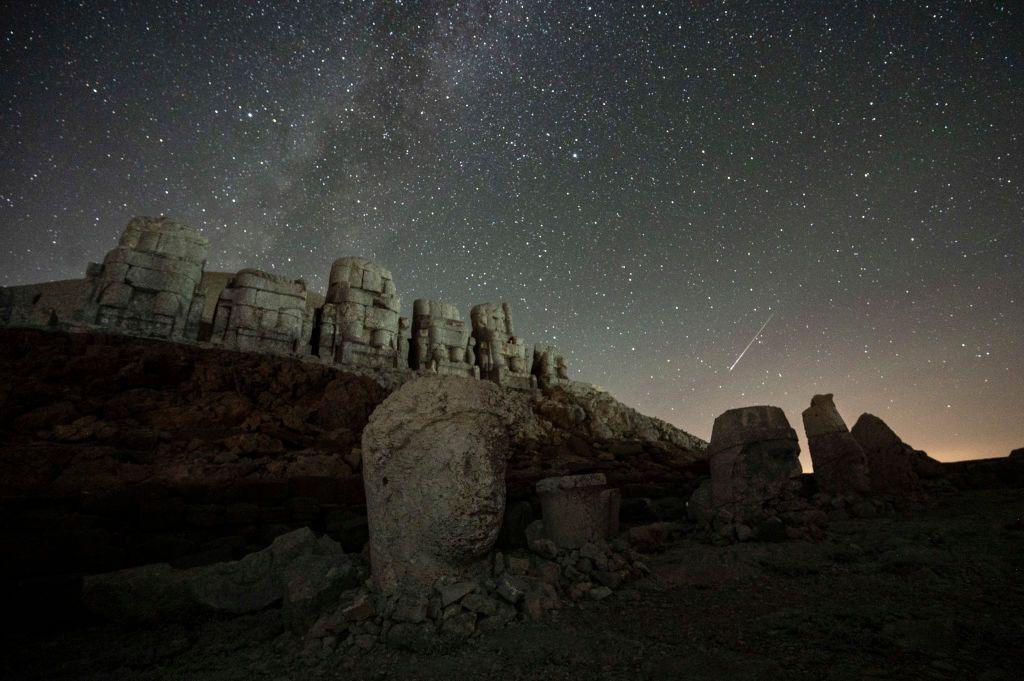 The Perseid meteor shower passes over sculptures at Mount Nemrut in Adiyaman, south-eastern Turkey