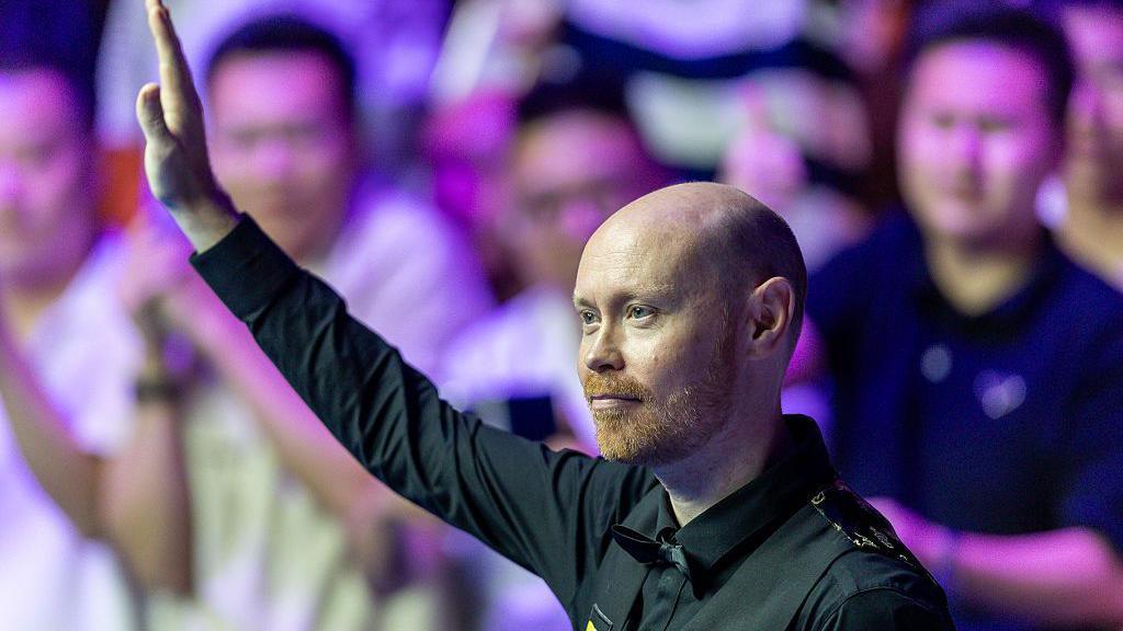 Gary Wilson of England gestures after defeated by Xiao Guodong of China in the final match on day seven of the WST 2025 Wuhan Open at the Optics Valley Gymnasium of Huazhong University of Science and Technology 