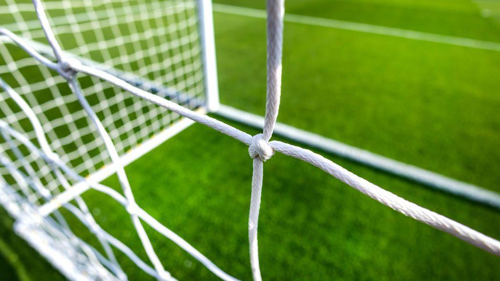 A generic goalmouth, with a close-up picture of a net 