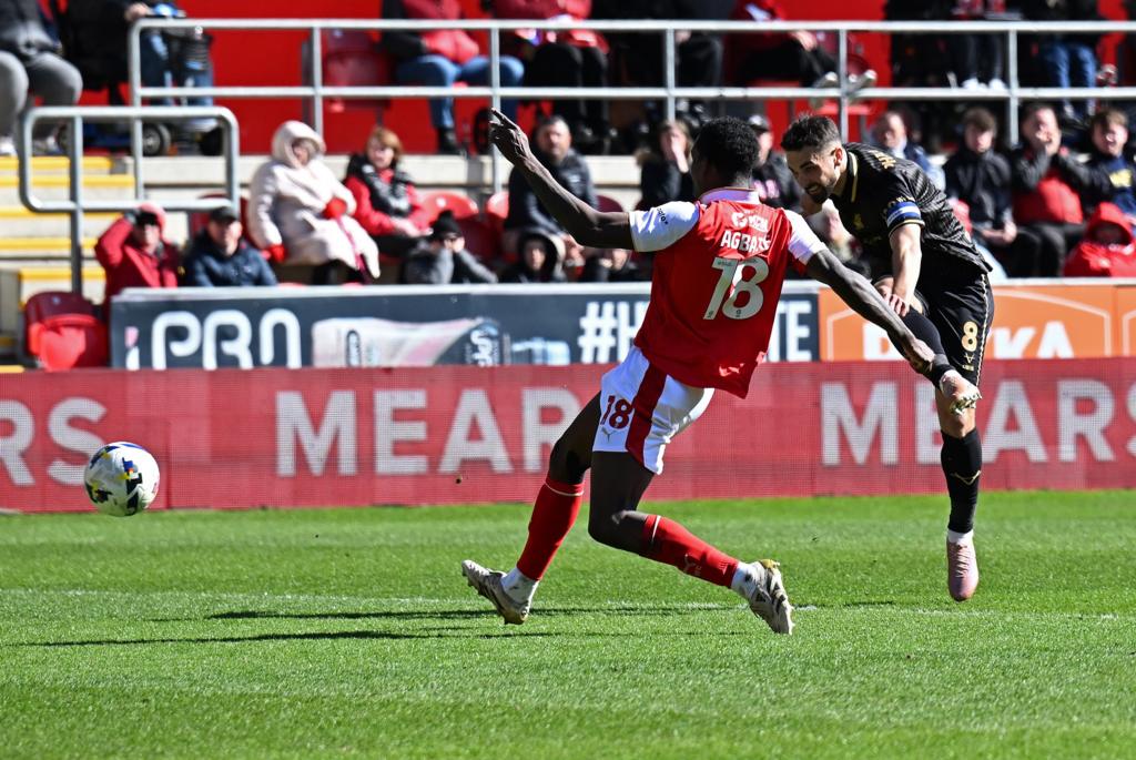 Barnsley's Adam Phillips scores a goal while Rotherham's Lenny Agbaire is defending