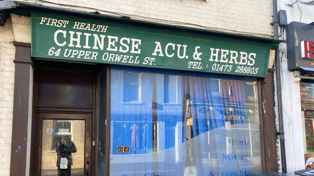 A shop front, showing the branding "first health, Chinese ACU. & Herbs" and the address 64 Upper Orwell Street.