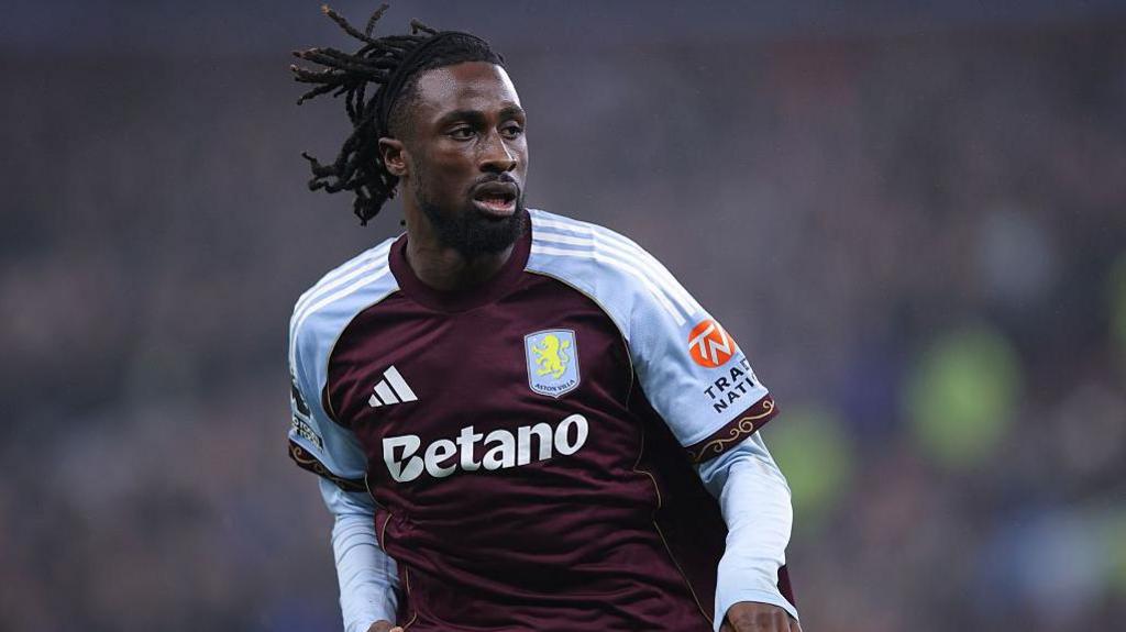 Evann Guessand wearing a claret and blue Aston Villa shirt