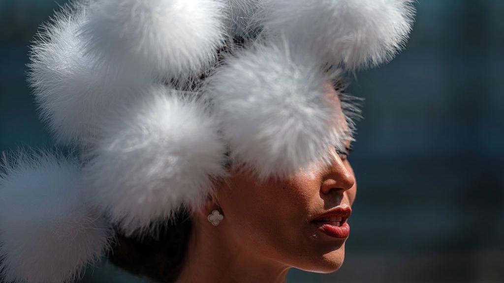 A woman chats with friends at Ascot Racecourse on June 19, 2025 in Ascot, England. Ladies Day at Royal Ascot is traditionally where the focus is on the fashion and style of women attending the annual race meeting.