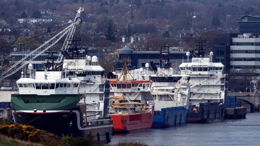 A row of large ships harboured in Aberdeen