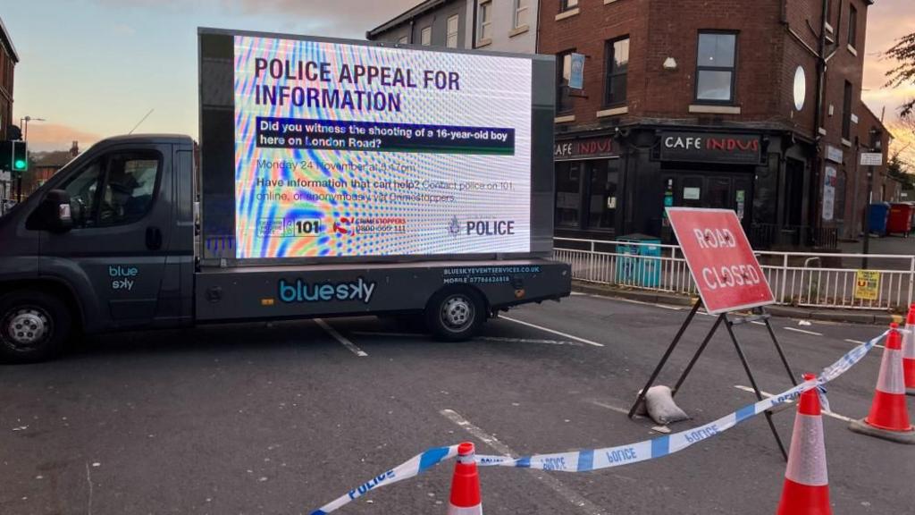 Police sign appealing for information next to a cordon