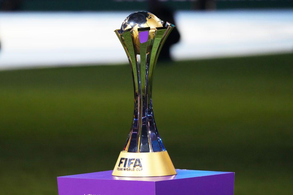 The Fifa Club World Cup trophy sits on a plinth in front of a football pitch