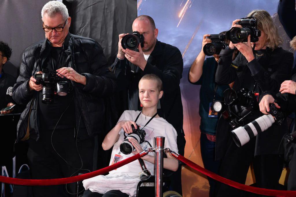 Liz Hatton alongside press photographers during the UK premiere of Venom: The Last Dance on 23 October.