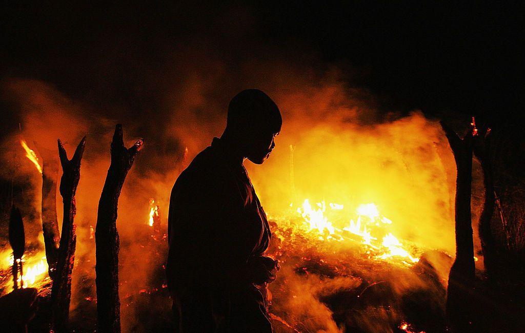 A Sudanese rebel fighter sombrely watches the abandoned village of Chero Kasi burn less than an hour after Janjaweed militiamen set it ablaze in the violence plagued Darfur region on 7 September 2004