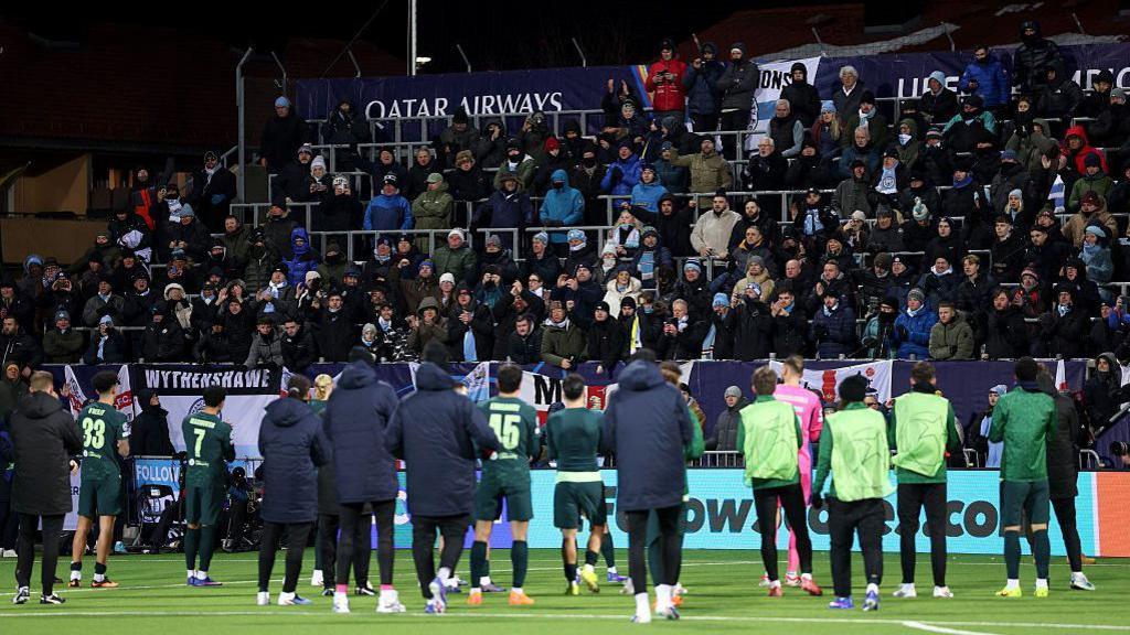 Man City players applauding the travelling fans. 