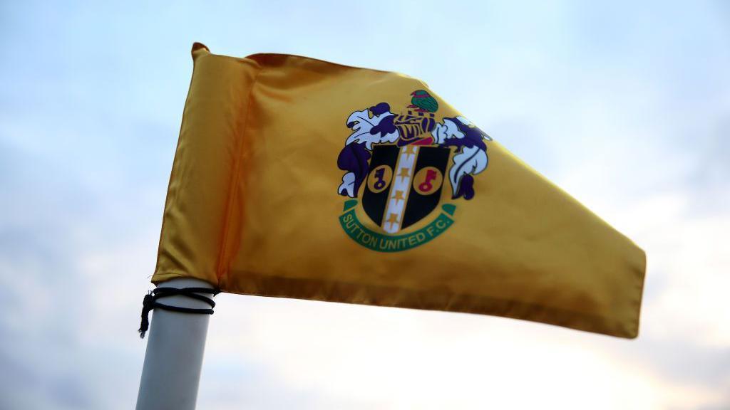 The Sutton United logo on a corner flag