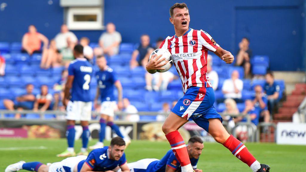 Alfie Rutherford of Dorking Wanderers celebrates scoring a goal to make the score 3-2 during the Vanarama National League match between Oldham Athletic and Dorking Wanderers at Boundary Park 