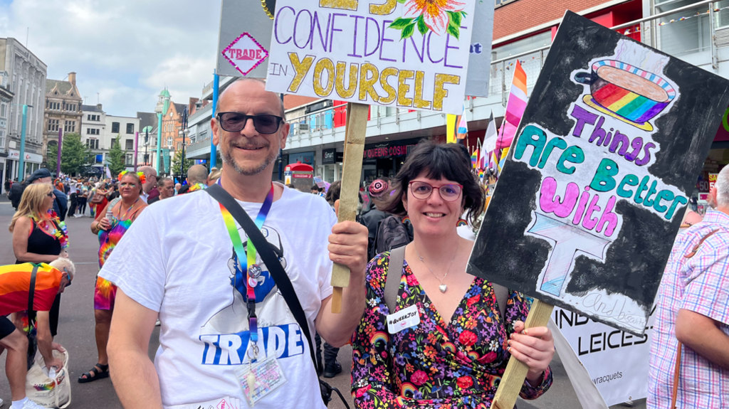 Representatives from Trade Sexual Health - a local charity - carrying placards at the Pride parade in Leicester