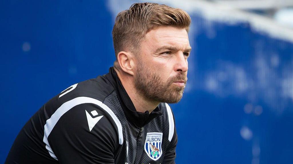 James Morrison watches on from the dugout 